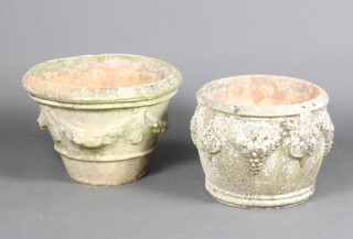 A well weathered circular garden urn of waisted form and swag decoration 35cm h x 46cm and 1 other similar 31cm x 38cm 
