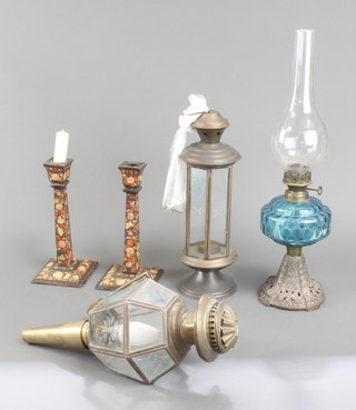 A pair of painted wooden candlesticks, part of an oil lamp and two hanging lamps 