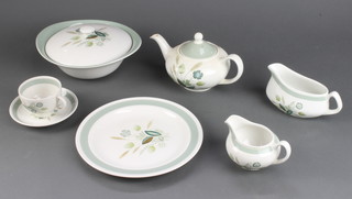 A Woods Ware Clovelly pattern tea and dinner service comprising 9 teacups, 7 saucers, 6 small plates, 4 medium plates, 7 dinner plates, a tureen and cover, 7 large plates, teapot, cream jug, sauce boat, 6 dessert bowls