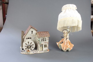A porcelain table lamp in the form of a lady, a porcelain model of a watermill (chipped)