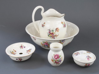 A 5 piece floral pattern wash set comprising jug, bowl, 2 soap dishes, toothbrush and jug 