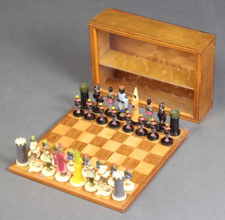 A plastic chess set with polychrome figures together with a chess board
