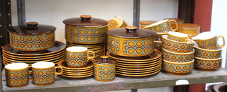 A Hornsea Bronte pattern part table service comprising 6 coffee cups, 5 saucers, sugar bowl and lid, milk jug, cream jug, 3 casseroles, 8 dessert bowls, 13 side plates, 8 breakfast plates, 6 dinner plates, a serving plate, 8 breakfast bowls and 3 lidded jars
