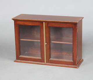 An Edwardian mahogany table top display cabinet, fitted shelves enclosed by glazed panelled door 36cm h x 53cm w x 19cm d 