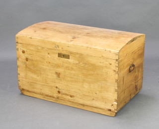 A Continental dome shaped stripped and polished pine coffer with iron drop handles 52cm x 86cm x 49cm 
