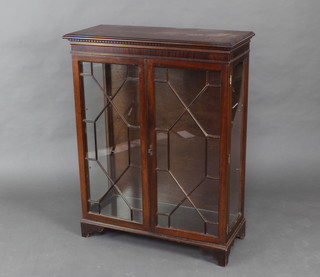 A Georgian style mahogany display cabinet with moulded and dentil cornice, fitted shelves enclosed by astragal glazed panelled doors, raised on bracket feet 109cm h x 85cm w x 37cm d 