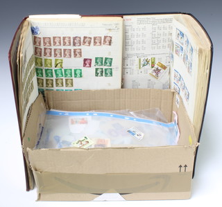 Two stock books of used Elizabeth II GB stamps and a collection of loose stamps some on paper 