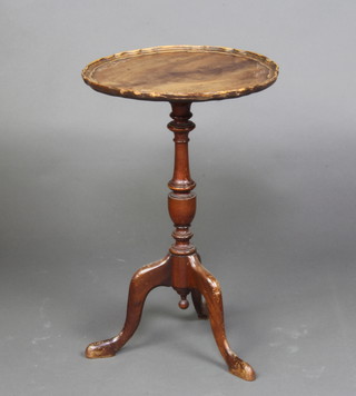 A circular Queen Anne style walnut wine table with pie crust edge raised on a pillar and tripod supports 54cm h x 35cm diam 