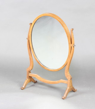A Queen Anne style oval plate dressing table mirror contained in a swing frame 61cm h x 21cm w x 40cm 