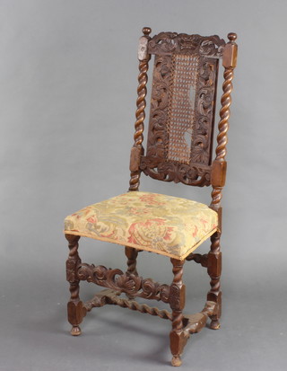 A Carolean style carved walnut and oak chair with woven cane seat and pierced stretcher (f) on spiral turned supports (the back has 2 bracing supports)  