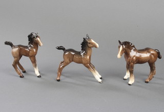 A Beswick figure of a shire foal (small) 1053 by Arthur Greddington 12.7cm, a ditto comical foal figure 728 by Arthur Greddington 12.7cm and a foal (large stretched) 836 by Arthur Greddington 12.7cm 