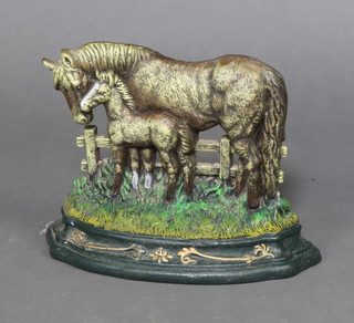 A cast iron doorstop in the form of a standing horse and foal 23cm h x 32cm w x 12cm 