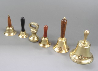 5 various brass hand bells and a 2lb brass bell weight 