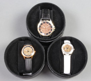 A gentleman's wristwatch set a 1962 half penny, two ladies wristwatches set a 1952 and a 1962 threepenny bit 