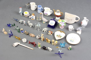 A miniature Wedgwood blue Jasperware jug, various miniature glass figures, Wade figures etc
