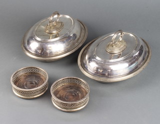 A pair of silver plated entree dishes and covers and a pair of coasters 