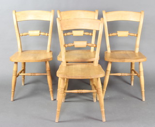 A set of 4 pine windsor style dining chairs