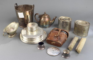 A silver plated ice bucket, 2 silver backed brushes, a pair of binoculars and minor plated wares 