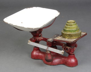 A pair of pan scales together with 5 brass graduated weights