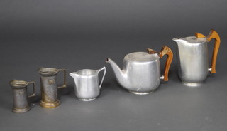 A 3 piece Picquot Ware tea service with teapot, hotwater jug and milk jug together with 2 Continental metal measures 