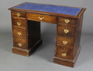 A Victorian mahogany desk with blue inset writing surface fitted 1 long and 8 short drawers raised on a platform base 76cm h x 106cm w x 56cm d (There is some scuffing and water damage to the top, 1 handle is missing )