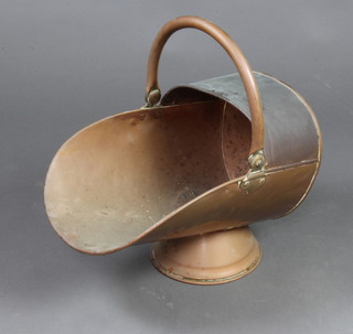 A copper helmet shaped coal scuttle 
