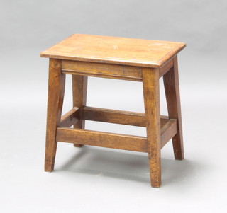 A rectangular oak stool raised on square tapered supports with stretcher 47cm h x 46cm w x 30cm d (ring marks and split to the top) 
