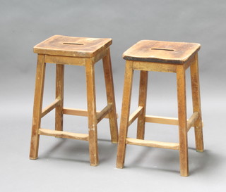 A pair of beech laboratory style stools 55cm h x 30cm w x 30cm d (both with repair to stretcher) 