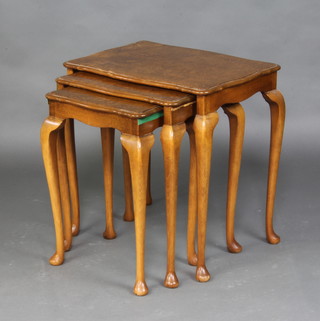 A nest of 3 Queen Anne style figured walnut interfitting coffee tables with pie crust edge and raised on cabriole supports 54cm h x 53 cm w x 39cm d