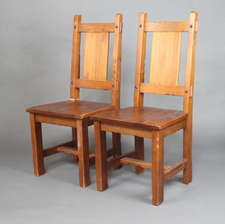 A pair of hardwood slat back dining chairs 
