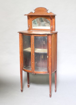 An Edwardian inlaid mahogany bow front display cabinet with raised mirrored back enclosed by glazed panelled doors, raised on square tapered supports, spade feet 132cm h x 55cm w x 37cm d  (some contact marks and water damage) 