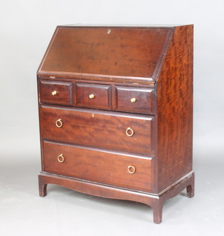 A Stag mahogany bureau, with fitted interior above 3 short and 2 long drawers 99cm h x 76cm w x45cm d