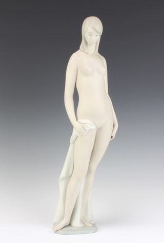 A Lladro figure of a naked lady holding a cloak, matt finish, 47cm 