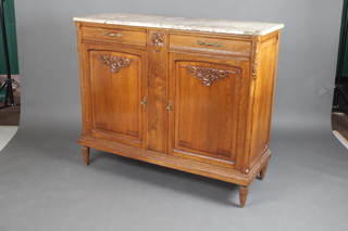 A French carved oak Art Nouveau sideboard with pink veined marble top fitted 2 drawers above a double cupboard enclosed by panelled doors, raised on turned and reeded supports 104cm h x 123cm w x 46cm d  