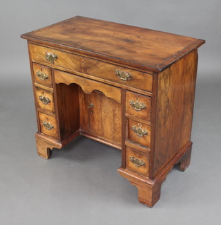 A George II mahogany desk/dressing table fitted 1 long drawer above a secret drawer, the pedestal fitted a cupboard and flanked by 6 short drawers, raised on bracket feet 72cm h x 79cm w x 44cm d 