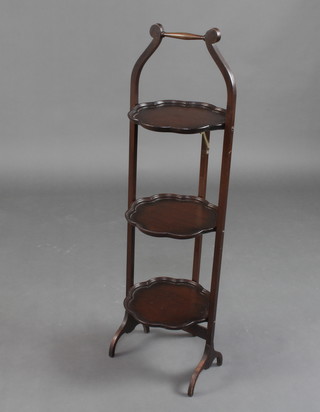 A 1920's Chippendale style circular 3 tier folding cake stand with bracketed border 94cm h x 26cm diam. 