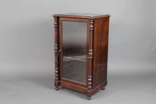 A Victorian mahogany music cabinet fitted shelves enclosed by a glazed panelled door with turned and fluted columns to the sides 39cm x 54cm x 42cm 