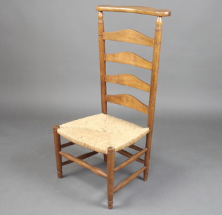 A French beech ladder back prie-dieu chair with woven rush seat 