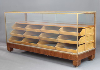 An Art Deco bronzed metal and oak drapers display cabinet fitted a shelf and 12 drawers, 87cm h x 183cm w x 61cm d 

