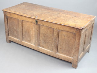 An 18th Century oak coffer of panelled construction with hinged lid and iron lock, the interior papered with 1857 editions of The London Illustrated News 60cm h x 136cm w x 59cm d  