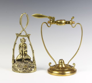A 1920's brass door stop decorated a Cornish pixie 24cm x 10cm x 3cm the back marked Elpec, together with an Art Nouveau brass spirit burner marked no. 8 on a circular base 23cm x 12cm 