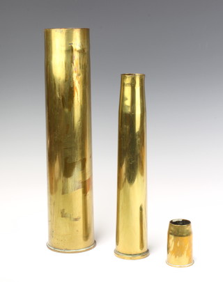 A First World War French brass shell case marked Schneider 1917, a Second World War anti aircraft shell case marked 40mm 1941 and a 1920's starting shell case marked 1929  