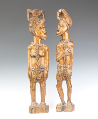 A pair of African carved double sided figures of a standing lady and gentleman 62cm h x 13cm w x 5cm d 

