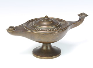 A 19th Century circular bronze Roman style oil lamp on a spreading foot, the top marked "In Lumine Tuo Videbimus Lumen" (In thy light we shall see light) 9cm h x 24cm w x 14cm   