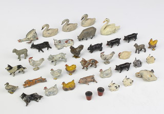Thirty four Britains farmyard figures including 2 plant pot, 4 pigs, 4 dogs, 4 swans, 4 cockerells, 4 laying hens, 2 chicks, duck, goose (foot f), swan? (f), sheep, 2 lambs, 2 cows, running hare and 4 rabbits 