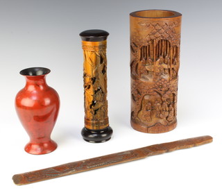 A circular carved bamboo brush pot 28cm x 11cm, a carved and pierced bamboo scroll case 23cm x 5cm, a red lacquered baluster shaped vase 18cm x 7cm together with a carved newspaper opener? 44cm x 4cm 

