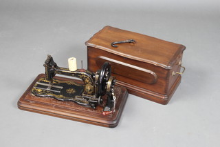 Bradbury and Company, a manual sewing machine no.146212 complete with instructions (creased and torn) and various tools