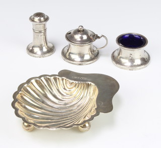 An Edwardian silver shell shaped butter dish Sheffield 1909, 3 condiments, 178 grams 