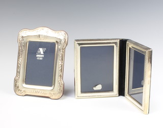 A folding double silver photograph frame and a repousse ditto  