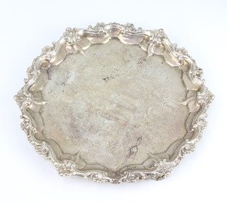 A Victorian silver card tray with scroll border and chased decoration on scroll feet, London 1851, 23cm, 515 grams